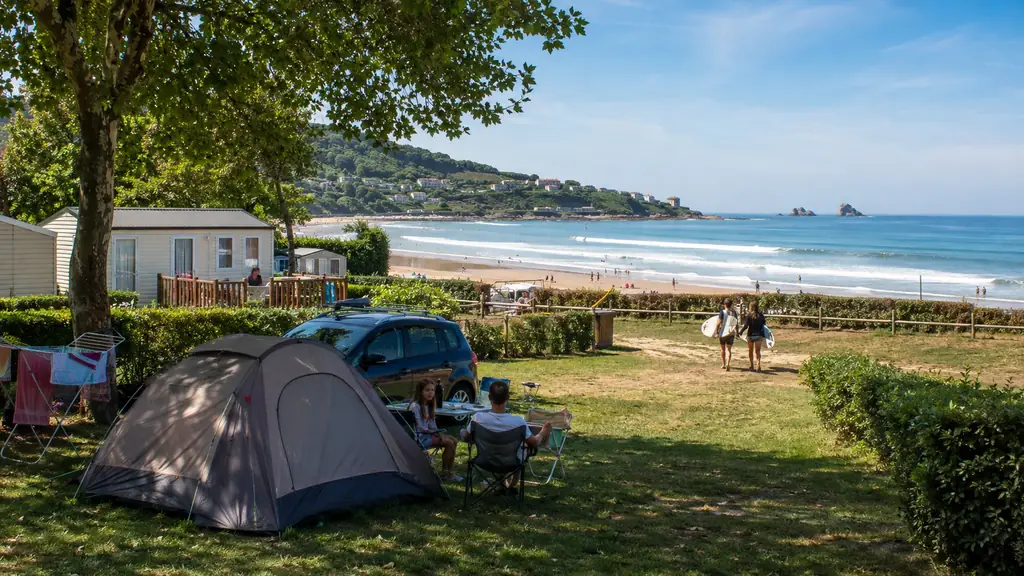 Camping à Hendaye près de la plage avec tentes, mobil-homes et surfeurs face à l’océan